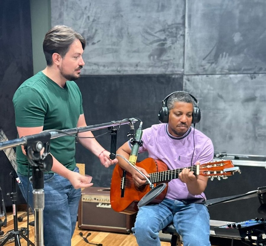 An IME instructor coaching a guitarist during a studio session