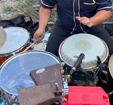 Hands on a set of percussion instruments during a workshop
