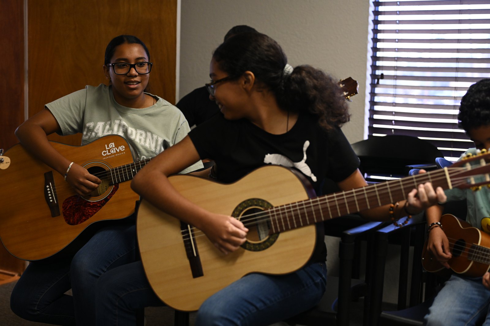 Sound Birth students playing guitar in a workshop