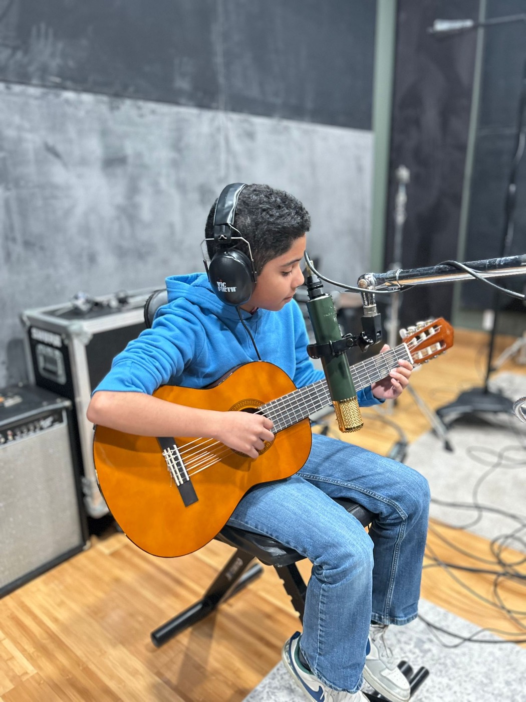 A Sound Birth Festival student recording classical guitar in the studio